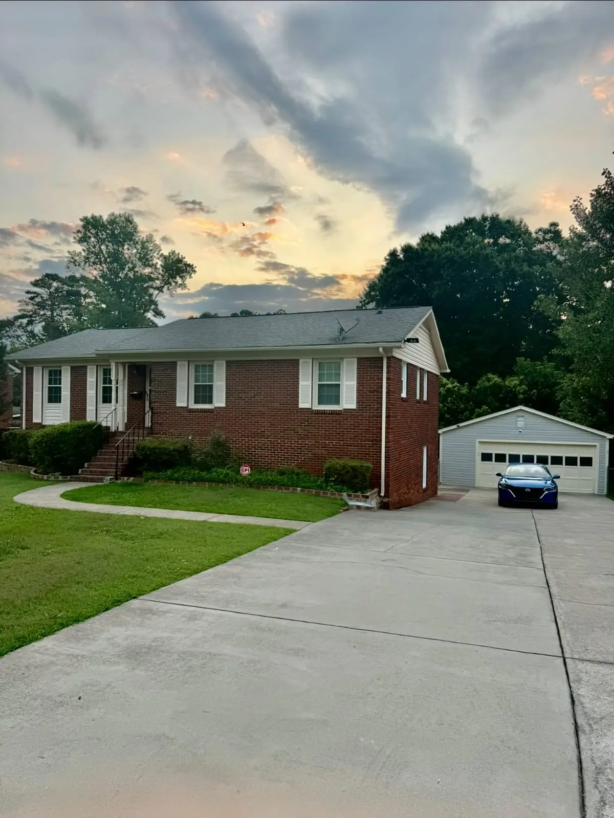 Sutter House at dusk, a brick 5-bedroom recovery home near Uptown Charlotte, NC