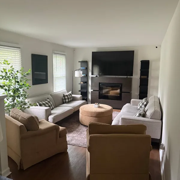 Shared living room at Sutter House with comfortable seating and a fireplace